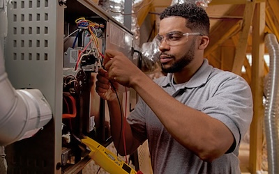 Careers 400 Technician working on furnace